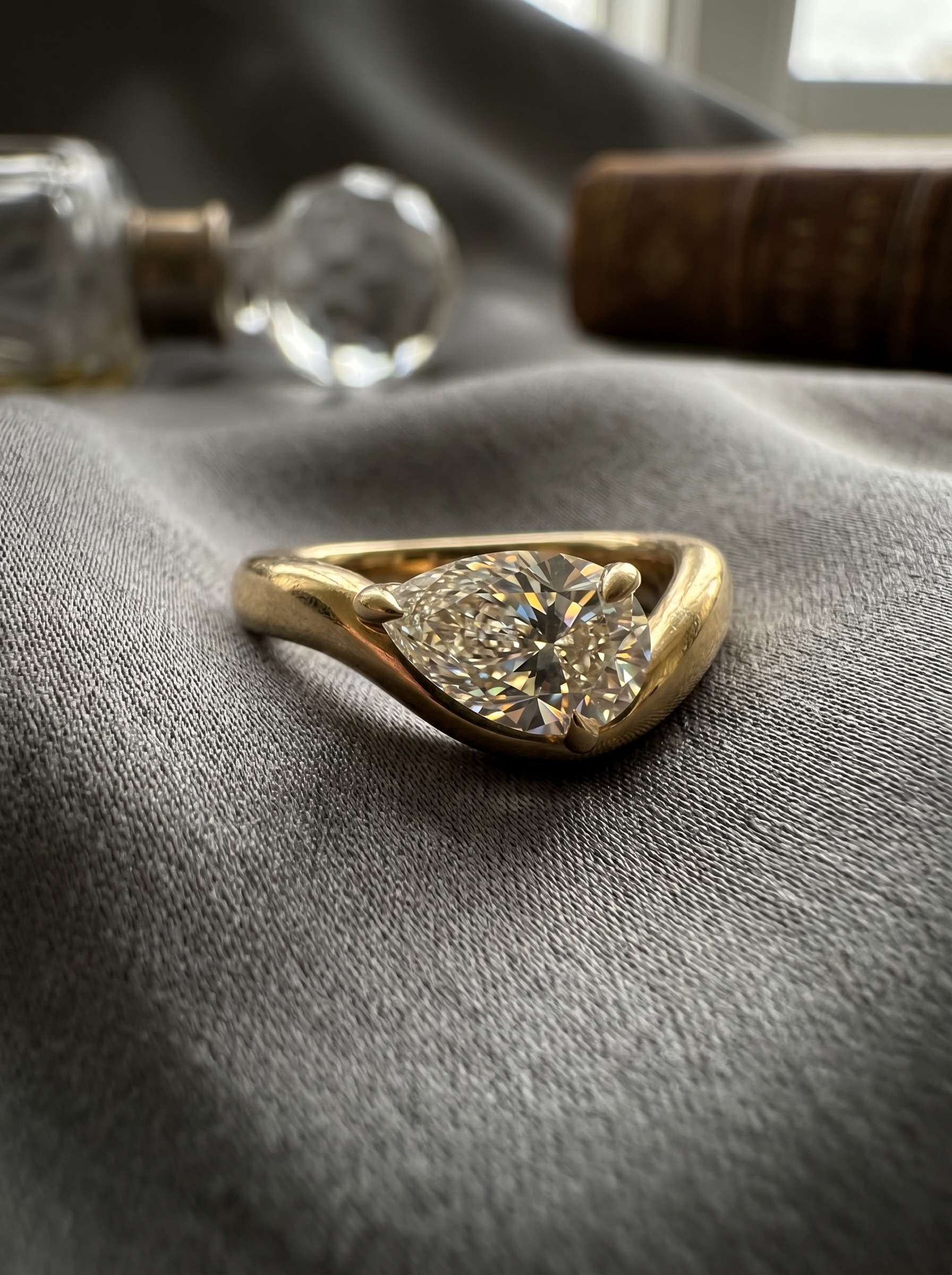 Hand resting on linen, gold ring catching the light